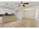 Open-concept living area with a breakfast bar, stainless steel appliances, and light wood flooring at 310 Tuggle Court, Woodstock, GA 30188