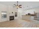 Open living space featuring a fireplace, kitchen, and stainless steel appliances, with natural light at 310 Tuggle Court, Woodstock, GA 30188