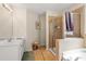 Bright bathroom with glass shower and double vanity at 564 Grand Ashbury Ln, Sugar Hill, GA 30518