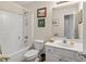 Bright bathroom with shower-tub combo and white vanity at 564 Grand Ashbury Ln, Sugar Hill, GA 30518