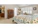 Cozy bedroom featuring large window with white shutters and classic wood dresser at 564 Grand Ashbury Ln, Sugar Hill, GA 30518