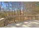 Wooden deck overlooking lush foliage and a creek at 564 Grand Ashbury Ln, Sugar Hill, GA 30518