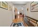 Hallway with wood floors leading to a living space with a fireplace at 564 Grand Ashbury Ln, Sugar Hill, GA 30518