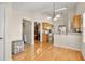 Sunlit breakfast nook connected to kitchen with hardwood floors, light cabinetry, and a charming view into the living area at 564 Grand Ashbury Ln, Sugar Hill, GA 30518