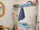 Functional laundry area with shelving unit for storage at 564 Grand Ashbury Ln, Sugar Hill, GA 30518