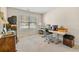 A basic office space with neutral walls, a large window and a desk at 564 Grand Ashbury Ln, Sugar Hill, GA 30518