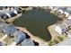 Overhead shot shows the pond surrounded by attractive homes, creating a peaceful community ambiance at 1295 Leisure Lake Dr, Lawrenceville, GA 30044