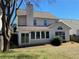 Backyard view highlighting the sunroom and chimney of this home with a grassy lawn at 1295 Leisure Lake Dr, Lawrenceville, GA 30044
