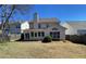 A backyard with a view of the home's rear, featuring a patio and well-maintained lawn at 1295 Leisure Lake Dr, Lawrenceville, GA 30044