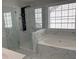 Modern bathroom featuring glass shower, soaking tub and beautiful tile at 1295 Leisure Lake Dr, Lawrenceville, GA 30044