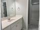 A clean bathroom featuring a vanity with a sink, and a shower with sliding glass doors at 1295 Leisure Lake Dr, Lawrenceville, GA 30044