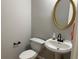 Well-lit half bathroom featuring a pedestal sink and modern fixtures at 1295 Leisure Lake Dr, Lawrenceville, GA 30044
