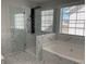 Sleek bathroom with a glass shower, soaking tub, and modern finishes at 1295 Leisure Lake Dr, Lawrenceville, GA 30044