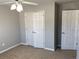 This bedroom features carpet, a closet with bi-fold doors, and white trim at 1295 Leisure Lake Dr, Lawrenceville, GA 30044