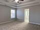 Spacious bedroom featuring tray ceiling, neutral walls and plush carpeting at 1295 Leisure Lake Dr, Lawrenceville, GA 30044
