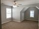 Carpeted bedroom with two windows and an angled ceiling showcasing natural light and cozy ambiance at 1295 Leisure Lake Dr, Lawrenceville, GA 30044