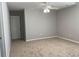 An empty bedroom with neutral paint, carpet flooring, a ceiling fan, and electrical outlets at 1295 Leisure Lake Dr, Lawrenceville, GA 30044