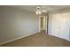 Neutral bedroom showing carpet, ceiling fan, gray walls, and closet with white doors at 1295 Leisure Lake Dr, Lawrenceville, GA 30044