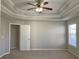 Spacious bedroom featuring plush carpet and a modern ceiling fan at 1295 Leisure Lake Dr, Lawrenceville, GA 30044