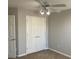 A cozy bedroom features neutral walls, ceiling fan with lights, and closet with double doors at 1295 Leisure Lake Dr, Lawrenceville, GA 30044