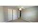 Neutral bedroom with a closet that has bi-fold doors, and a white door at 1295 Leisure Lake Dr, Lawrenceville, GA 30044