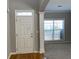 Welcoming entryway with a stylish white front door, large window, and neutral wall color at 1295 Leisure Lake Dr, Lawrenceville, GA 30044