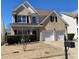 Two-story home with a brick facade, complemented by a manicured lawn and a double-car garage at 1295 Leisure Lake Dr, Lawrenceville, GA 30044