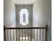 Upper hallway showcasing a chandelier beneath an arched window at 1295 Leisure Lake Dr, Lawrenceville, GA 30044