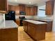 Bright kitchen with granite countertops, wooden cabinets, and modern stainless-steel appliances at 1295 Leisure Lake Dr, Lawrenceville, GA 30044