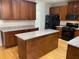 Spacious kitchen with wood cabinets, granite countertops, and a center island at 1295 Leisure Lake Dr, Lawrenceville, GA 30044
