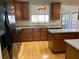 A kitchen featuring wood cabinets, stainless steel appliances, granite countertops, and hardwood floors at 1295 Leisure Lake Dr, Lawrenceville, GA 30044