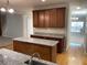 Kitchen with wood cabinets, granite countertops, island and open floor plan to living area at 1295 Leisure Lake Dr, Lawrenceville, GA 30044