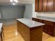 Kitchen with wood cabinets, granite countertops, island and open floor plan to living area at 1295 Leisure Lake Dr, Lawrenceville, GA 30044