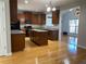Open kitchen with hardwood floors, an island, and a view into an adjacent room at 1295 Leisure Lake Dr, Lawrenceville, GA 30044