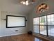 Inviting living room with large windows, ceiling fan, and a projector screen for entertainment at 1295 Leisure Lake Dr, Lawrenceville, GA 30044