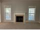 Living room with neutral colored carpet, fireplace and bright windows at 1295 Leisure Lake Dr, Lawrenceville, GA 30044