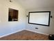Living room with projector screen, hardwood floors, and a view of the kitchen through a pass-through window at 1295 Leisure Lake Dr, Lawrenceville, GA 30044
