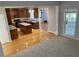 Open-concept living room with hardwood floors leading to the kitchen with an island at 1295 Leisure Lake Dr, Lawrenceville, GA 30044