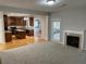 Open-concept living room featuring a fireplace and hardwood floors transitioning into a kitchen at 1295 Leisure Lake Dr, Lawrenceville, GA 30044