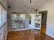 Sunlit living room featuring a large window, French doors, hardwood floors, and a projector for entertainment at 1295 Leisure Lake Dr, Lawrenceville, GA 30044