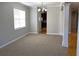 Open living space with carpet and an archway to a dining area with hardwood floors at 1295 Leisure Lake Dr, Lawrenceville, GA 30044