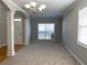 Light-filled living room featuring large windows and neutral carpeting at 1295 Leisure Lake Dr, Lawrenceville, GA 30044