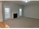 Living room with neutral colored carpet, fireplace and bright windows at 1295 Leisure Lake Dr, Lawrenceville, GA 30044