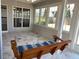 Cozy sunroom with hanging swing, tile floor, and an abundance of windows offering picturesque outdoor views at 1295 Leisure Lake Dr, Lawrenceville, GA 30044