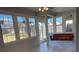 Bright sunroom with a swing, tile floors, and large windows offering serene outdoor views at 1295 Leisure Lake Dr, Lawrenceville, GA 30044