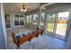 Beautiful sunroom with a comfortable swing, tile flooring, and sliding glass doors leading to the backyard at 1295 Leisure Lake Dr, Lawrenceville, GA 30044