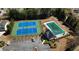 Aerial view of community tennis courts, clubhouse, parking, and pool at 1295 Leisure Lake Dr, Lawrenceville, GA 30044