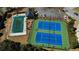 Aerial view shows community tennis courts, pool, and clubhouse surrounded by landscaping at 1295 Leisure Lake Dr, Lawrenceville, GA 30044