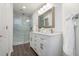 Modern bathroom featuring double vanities, a framed mirror, and a glass-enclosed shower, perfect for relaxation at 1303 Highland Bluff Se Dr # 303, Atlanta, GA 30339