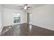 Bright bedroom featuring hardwood floors, window views, and easy access to balcony at 1303 Highland Bluff Se Dr # 303, Atlanta, GA 30339